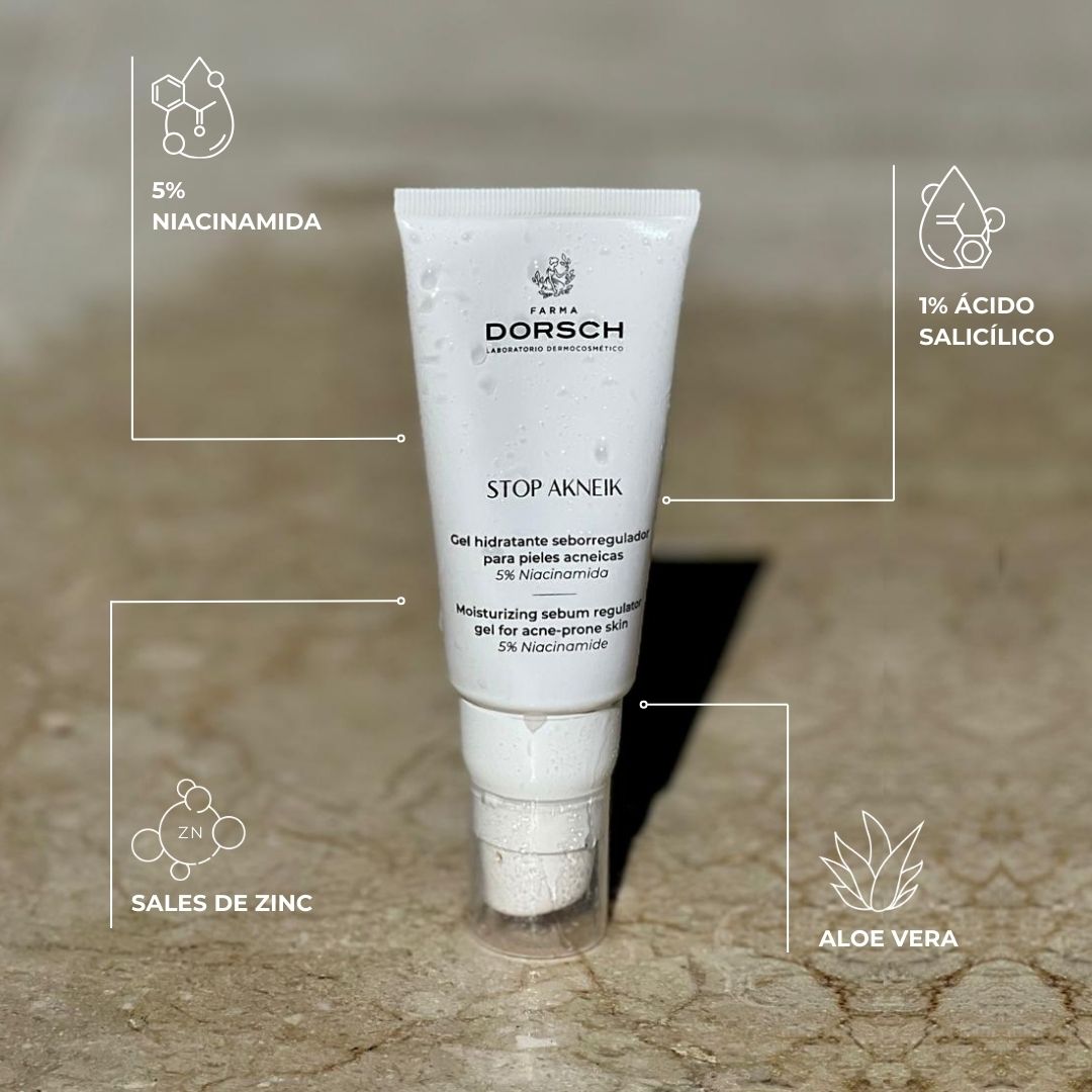 Imagen del gel STOP AKNEIK de FARMA DORSCH sobre superficie de mármol mojada, con gotas visibles en el envase. Fórmula clean ingredients con 5% niacinamida, 1% ácido salicílico, sales de zinc y aloe vera, diseñada para pieles acneicas. Hidrata, regula el sebo y calma la piel con imperfecciones.