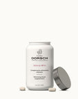 Envase abierto del complemento alimenticio Slim & Firm de Farma Dorsch, con cápsulas visibles sobre fondo claro.