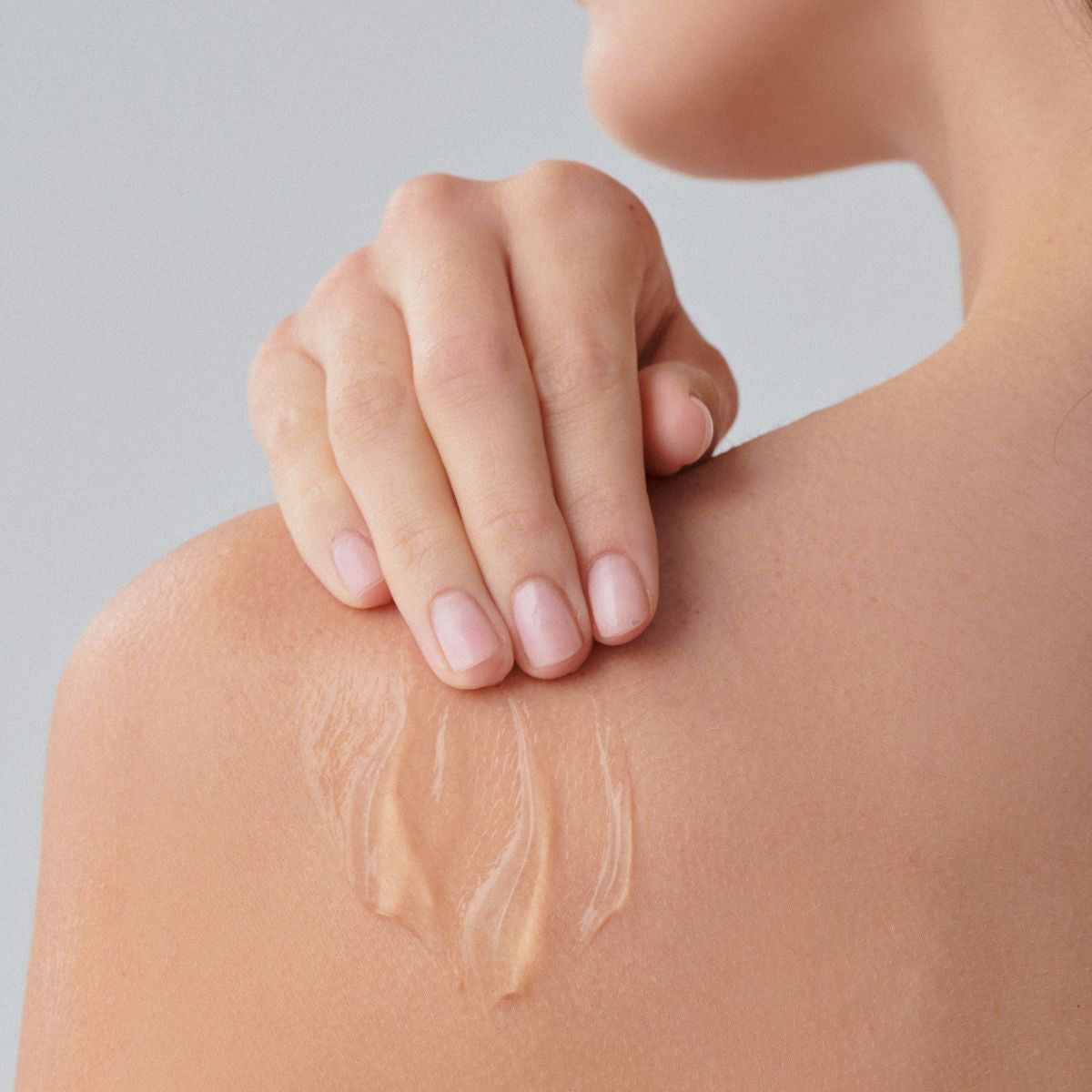 Mujer aplicando ALOE GEL de FARMA DORSCH en el cuerpo para refrescar e hidratar la piel después del sol.
