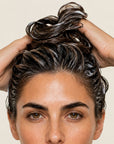 Mujer aplicando ACONDICIONADOR GO ORGANIC de FARMA DORSCH para conseguir un cabello más suave y fácil de peinar