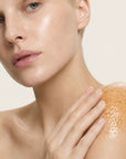 Mujer aplicando el exfoliante DERMO PEEL de FARMA DORSCH en el cuerpo para renovar la piel y dejarla más lisa y suave.